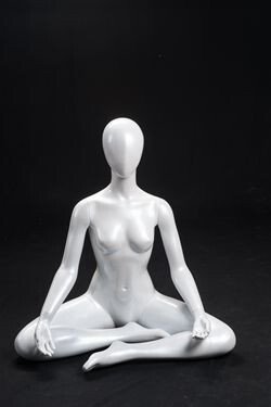 Gloss White Abstract Seated Yoga Egg Head Female Mannequin MM-YOGA1W Female mannequin with abstract faceless features, practicing yoga in seated OM pose. Made of gloss white fiberglass. Detachable arms, hands, torso and legs make them easy to dress. You can sell more athletic wear when using mannequins in active poses like this one.